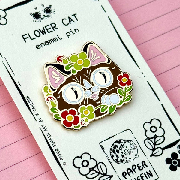 Flower cat enamel pin on a branded card with a pink background