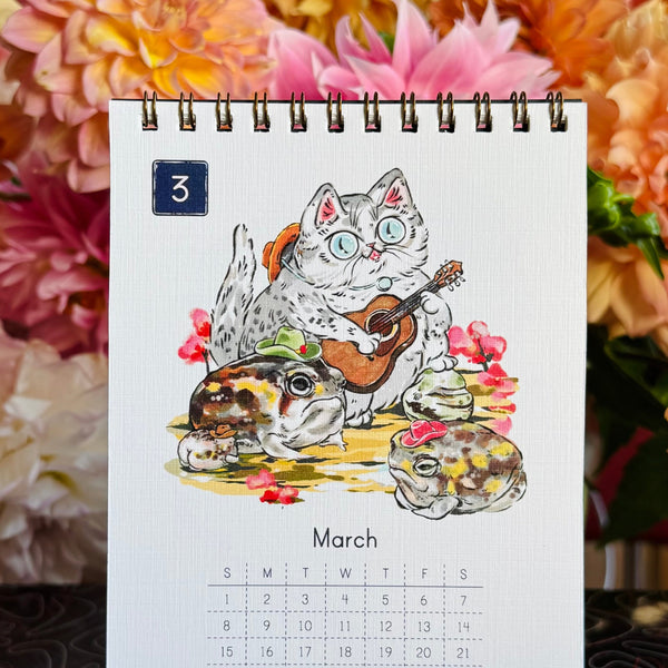 Calendar page for March with cat illustration surrounded by flowers